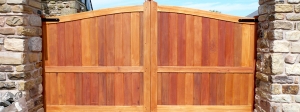 Framed solid arched top driveway gate