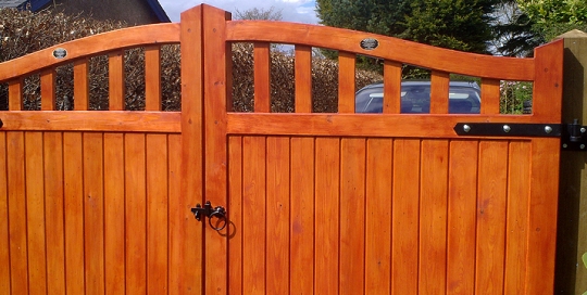 Framed part solid arched top driveway gate