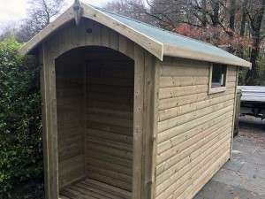 Bespoke shed with rear log store by Empress Fencing
