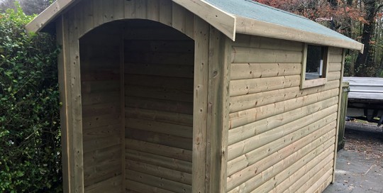 Bespoke shed with rear log store by Empress Fencing